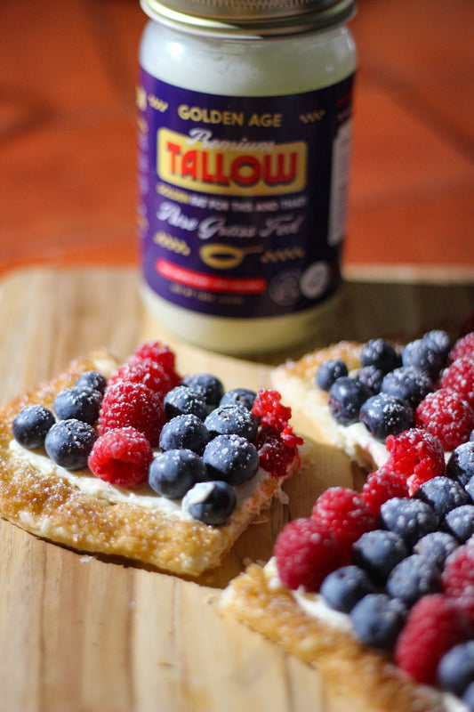 Festive summer tart featuring a crisp puff pastry base glazed with beef tallow, a creamy lemon-vanilla spread, and a vibrant topping of fresh berries.